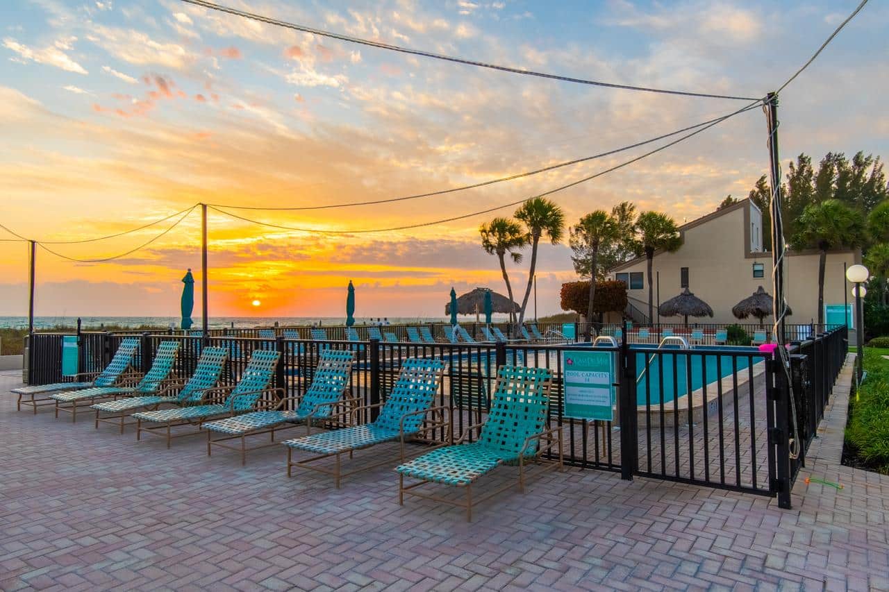 Casa Del Mar beachfront pool and lounge chairs at sunset